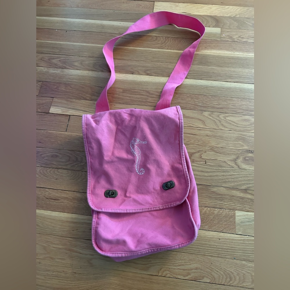 Used pink crossover pink bag with inside pocket with outer flap